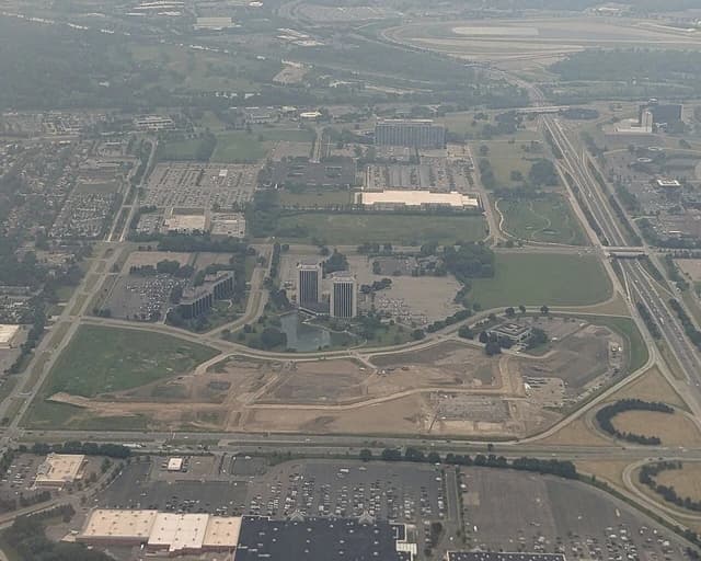 Aerial view showing the Ford Motor Company World Headquarters with surrounding buildings and roads.
