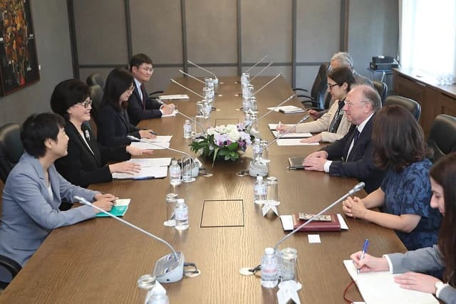 Svetlan Stoev and Ms. Jiang Yu seated at a large conference table with other delegates.