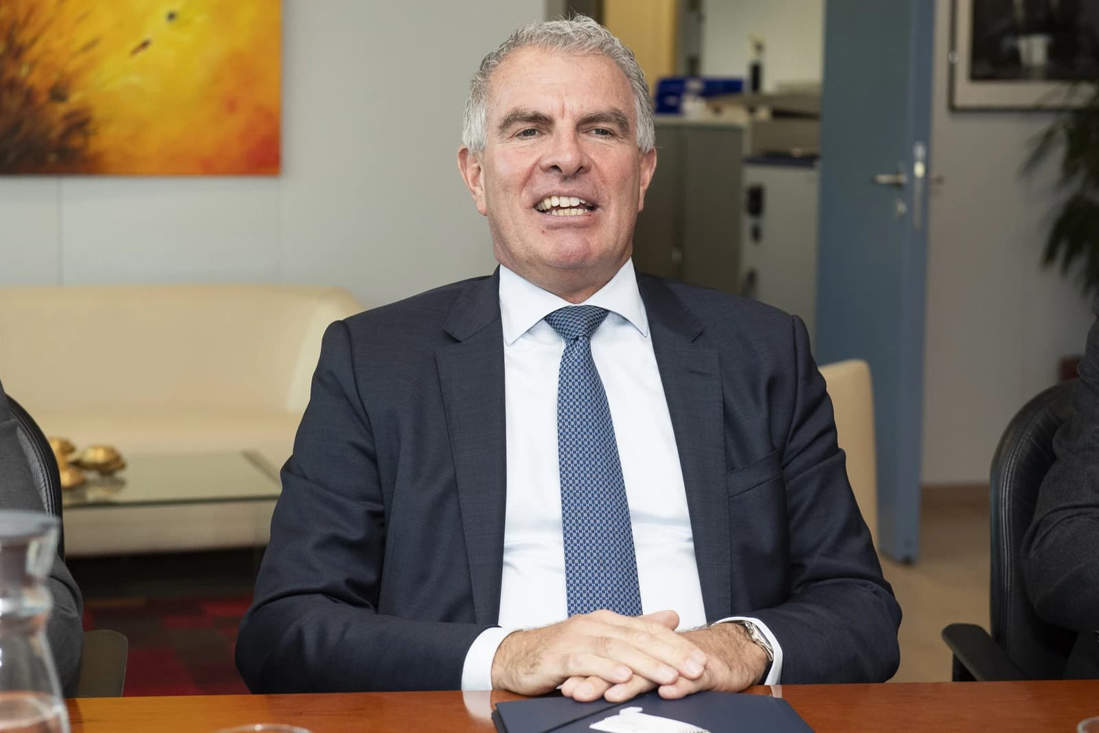 Carsten Spohr, CEO of Lufthansa, seated at a conference table.