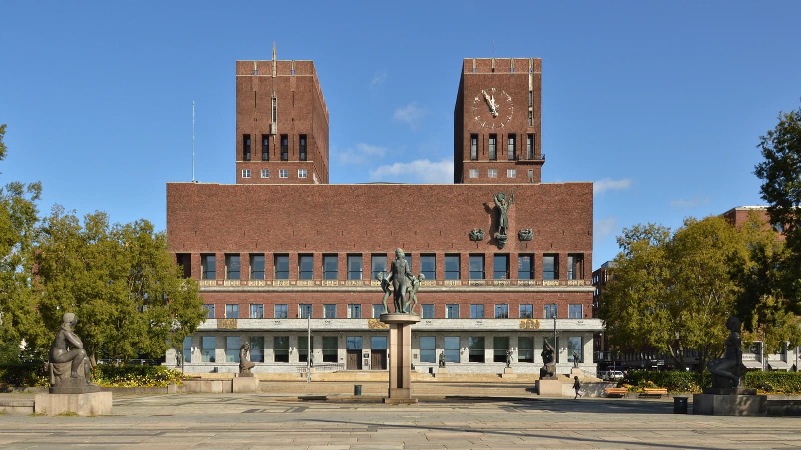 The brick facade of Oslo City Hall under a clear blue sky.