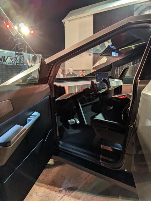 Interior of the Tesla Cybertruck showcasing the dashboard and steering wheel.