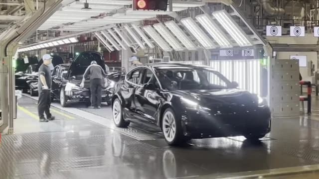 Tesla Model 3 electric vehicles move along an assembly line at the Tesla Gigafactory.