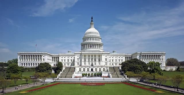 United States Capitol Building, west front, on a sunny day with green lawns.