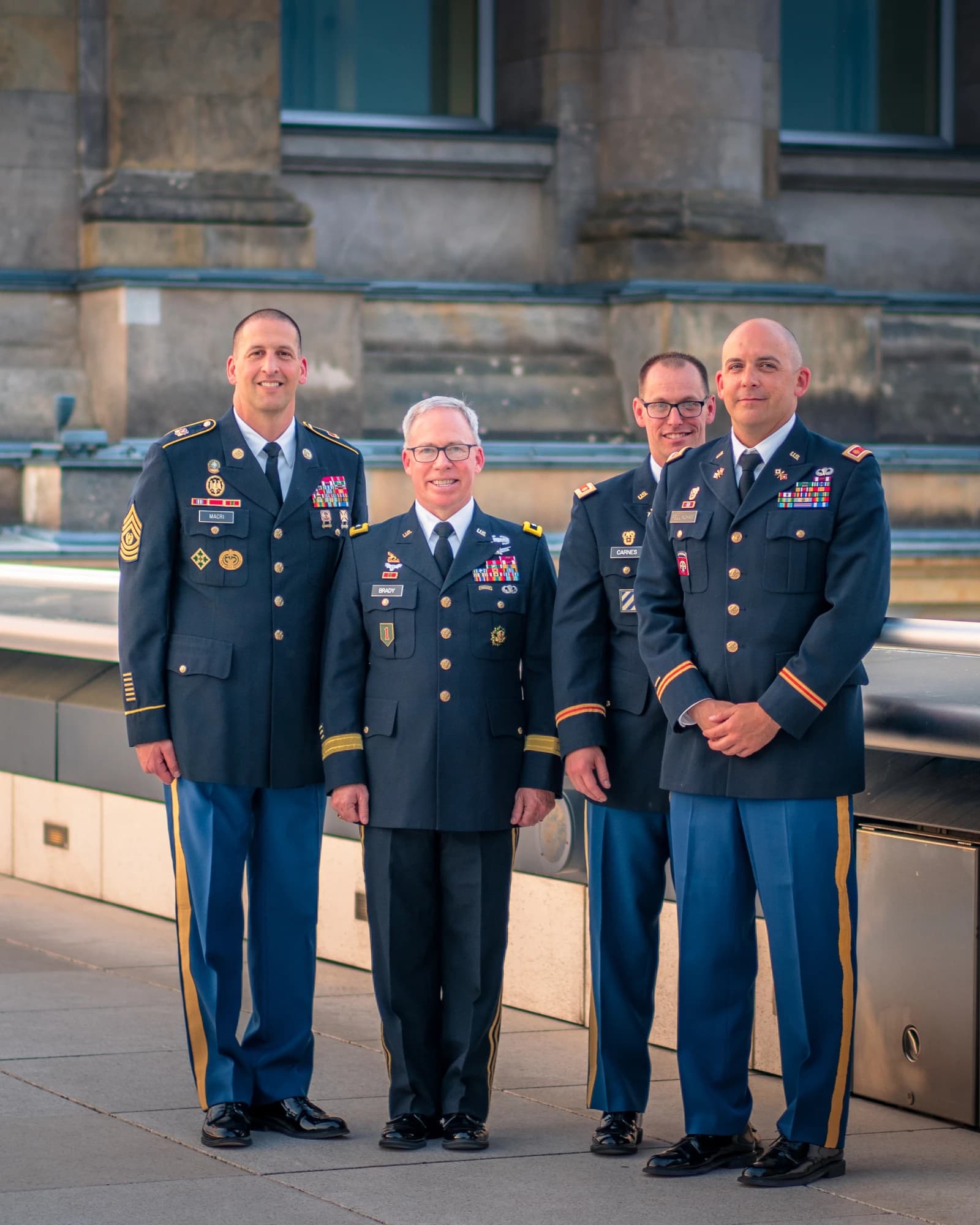 Maj. Gen. Brady and other military officers standing in front of a building.