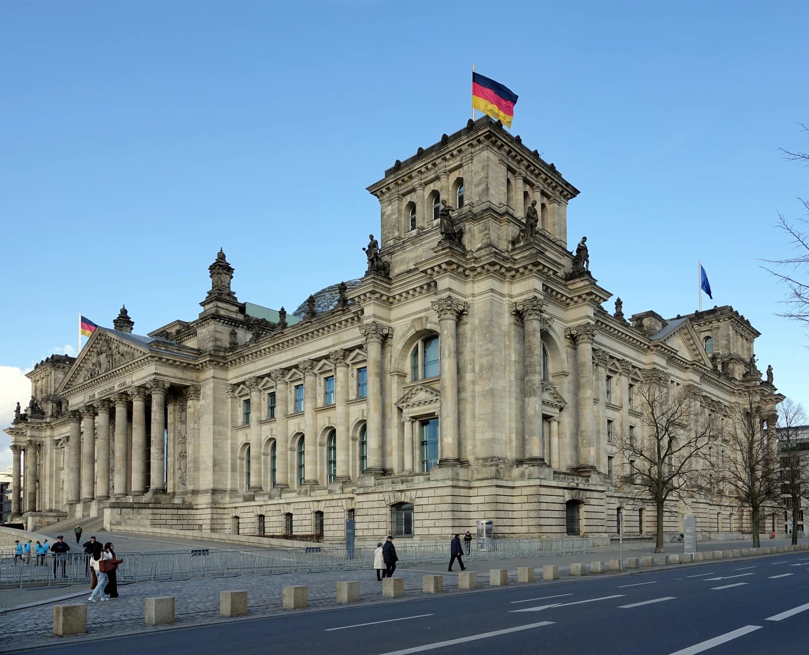 Exterior wide shot of the historic Reichstag building with German flag flying.