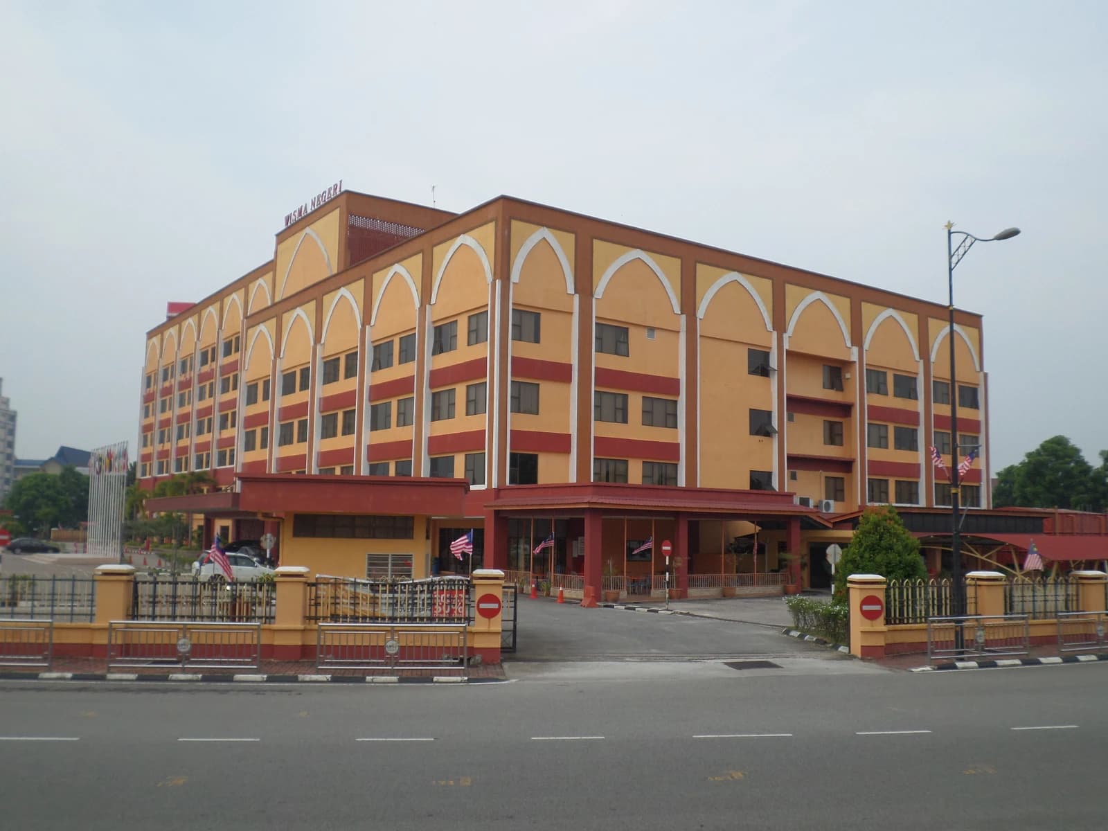 Melaka State Building, a large orange and brown administrative building, from across a road.