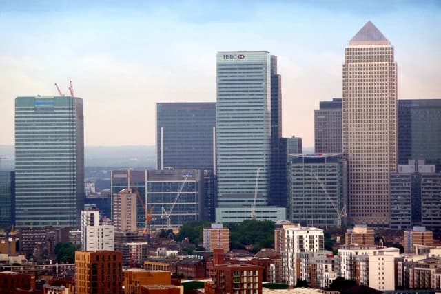 Overview of Canary Wharf financial district in London, featuring several tall skyscrapers.