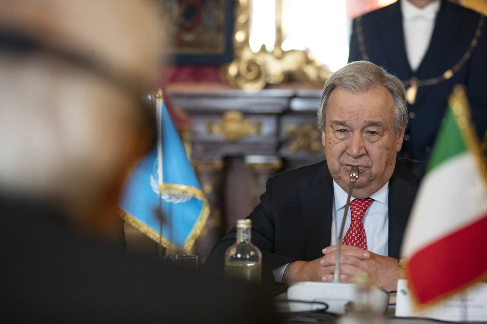António Guterres, UN Secretary-General, speaking at a meeting with a microphone in front of him.