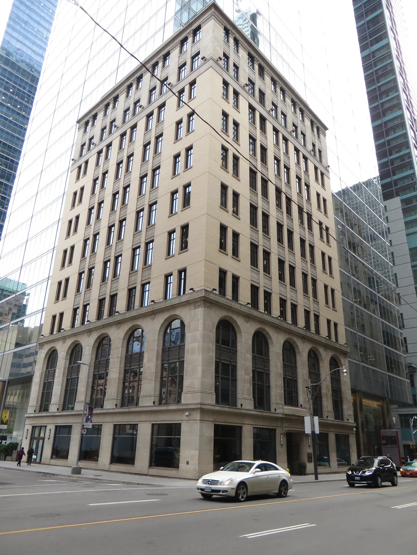 Financial district in Toronto, Canada, with buildings, street, and passing cars.