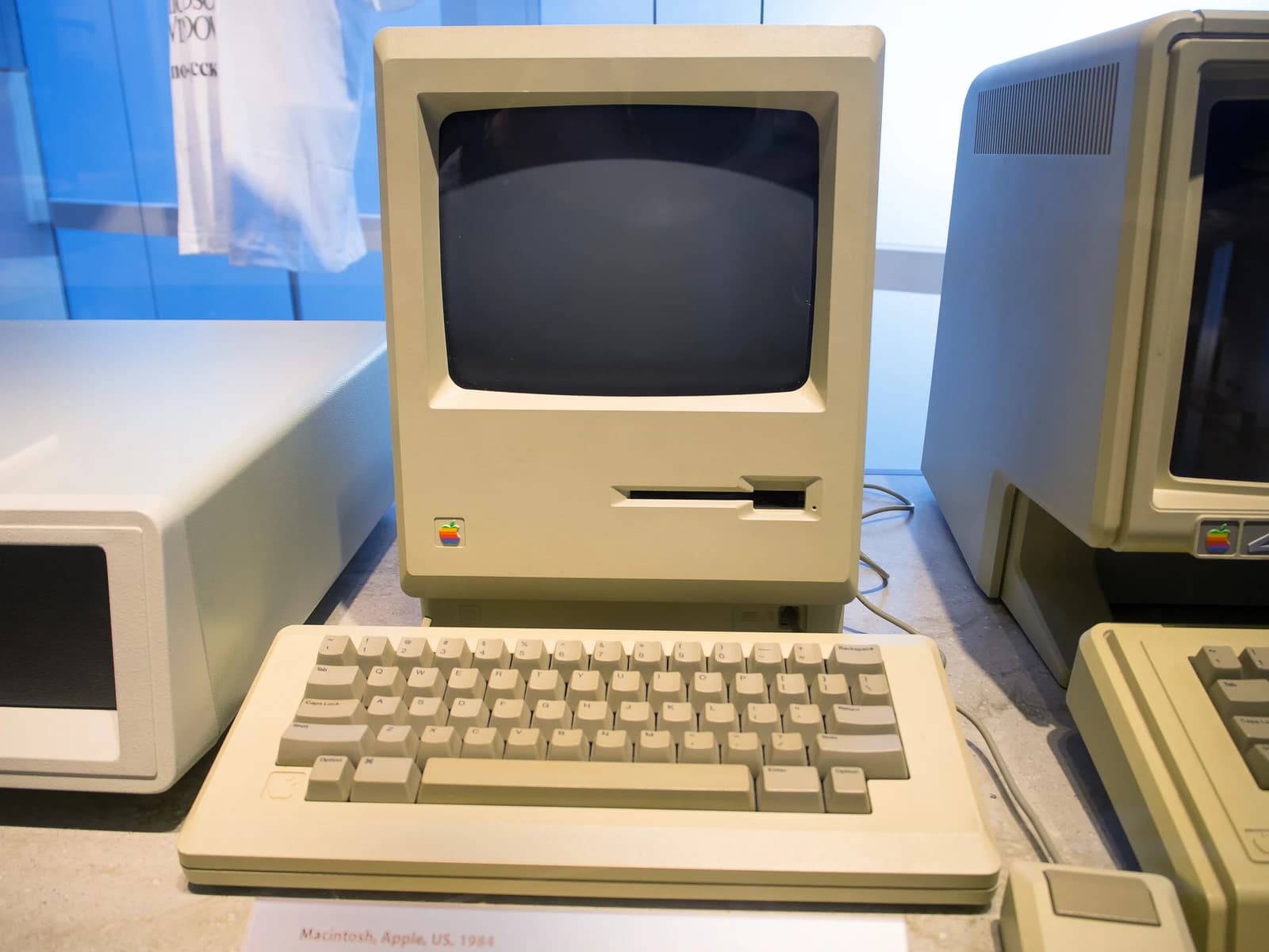 An original Apple Macintosh computer and keyboard on display.