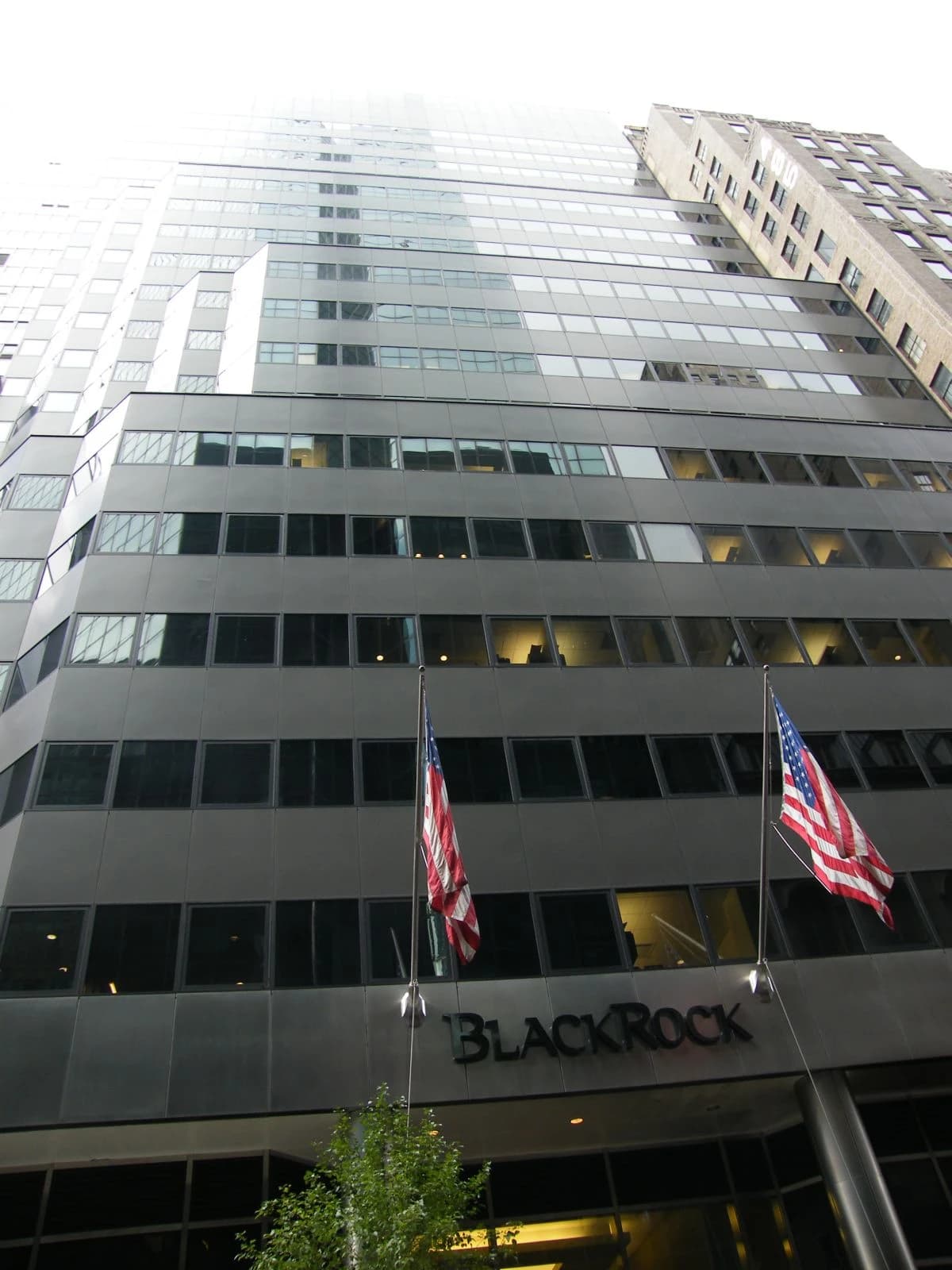 Exterior of BlackRock headquarters building in New York City with two American flags.