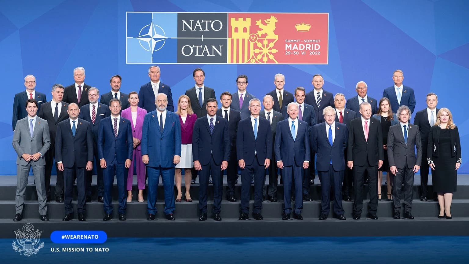 Heads of state and government from NATO member countries pose for a group photo.