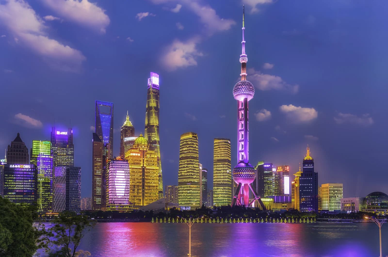 Pudong CBD skyline and Oriental Pearl TV Tower illuminate the night in Shanghai.