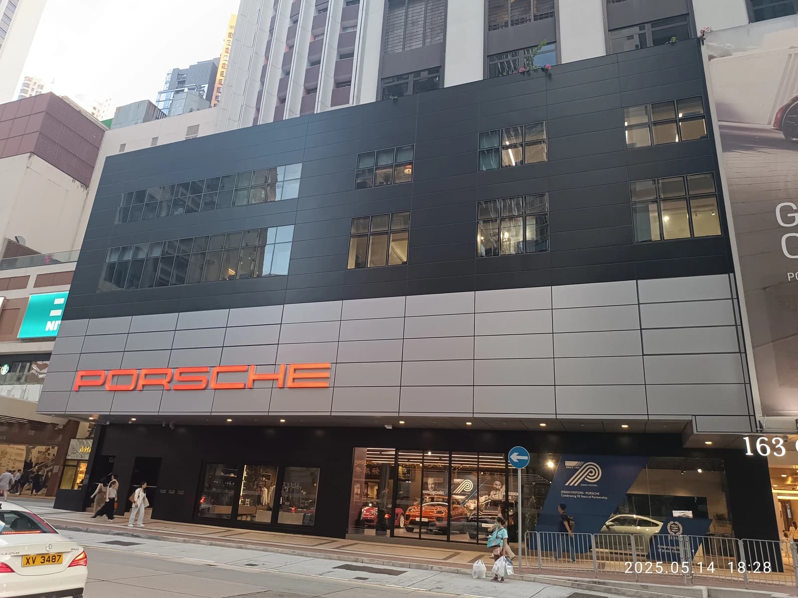 Exterior view of a Porsche automobile showroom on a city street.
