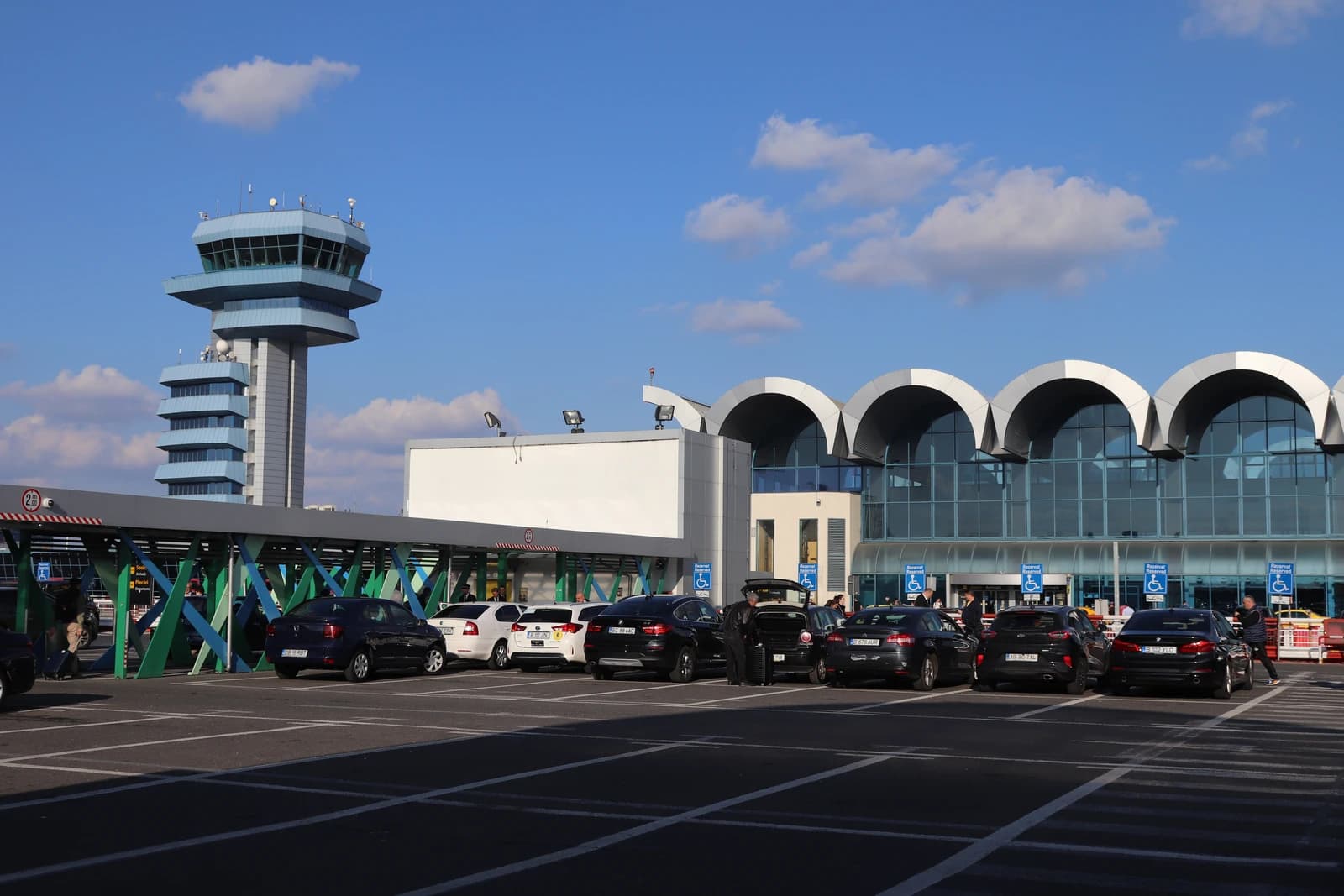 Henri Coandă International Airport in Otopeni, Romania, with control tower and terminal.