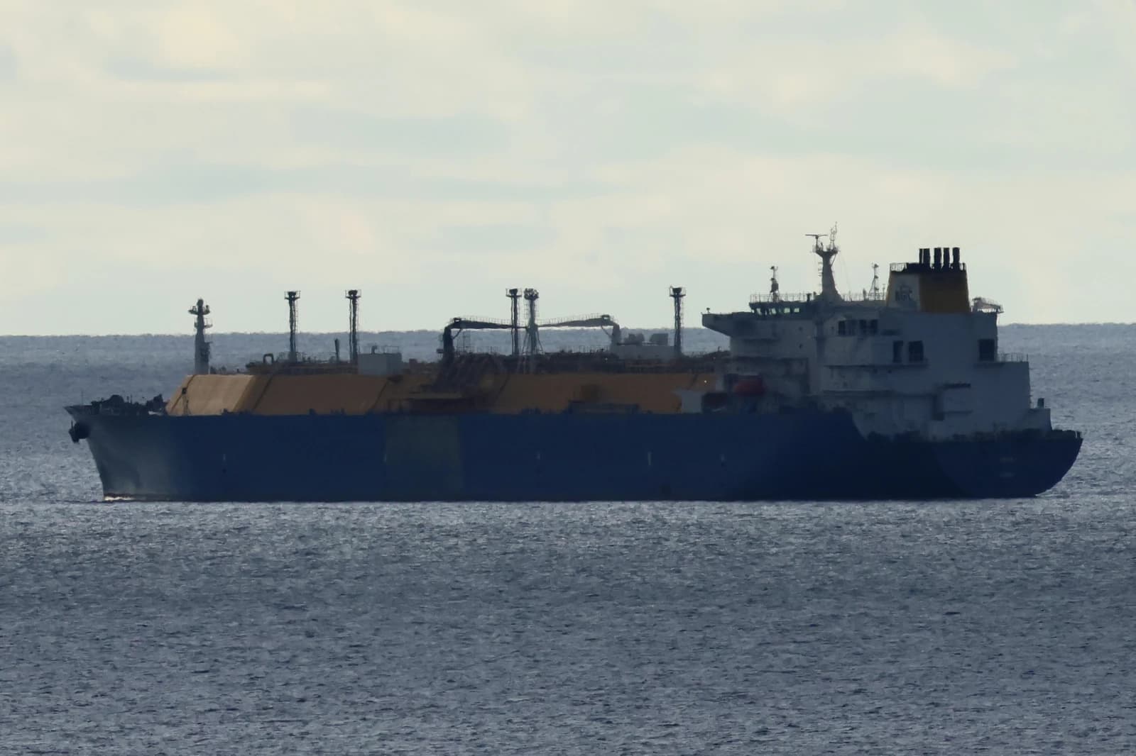 LNG tanker ARKAT sailing on open water under a cloudy sky.