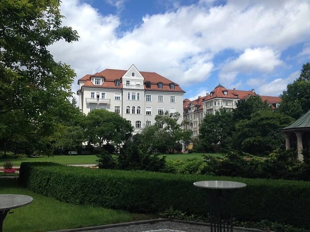 Buildings with red roofs at Munich Re headquarters seen from a courtyard.