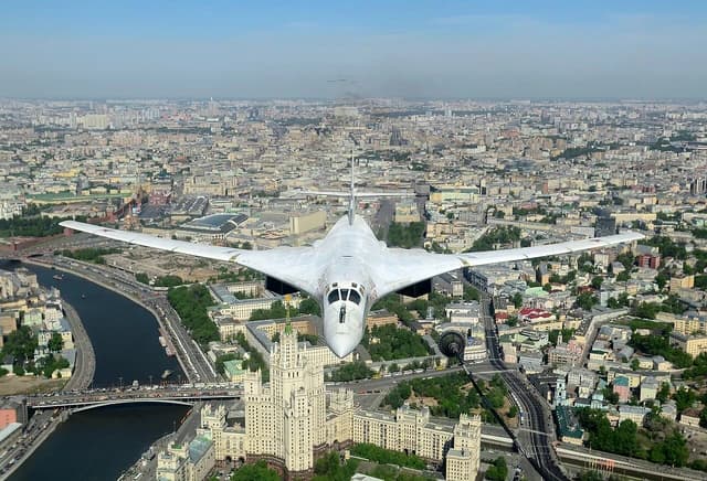 Tupolev Tu-160 bomber flying over buildings in Moscow, Russia.
