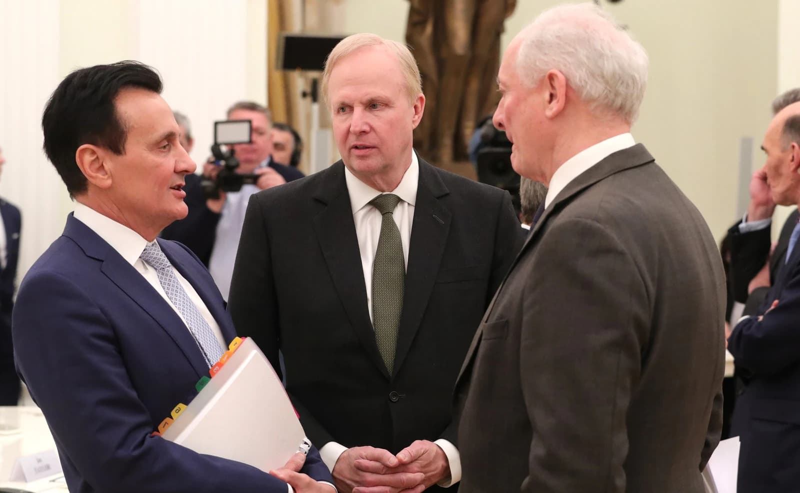 Pascal Soriot, Robert Dudley, and Roger Mannings in conversation at a formal gathering.