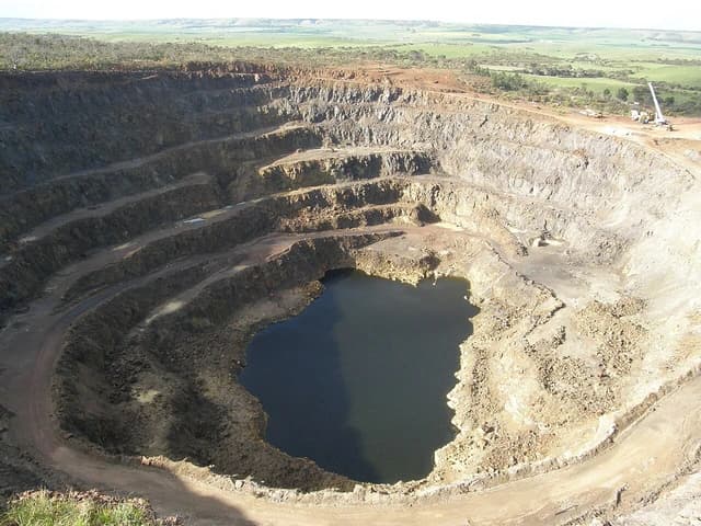 Aerial view of Kanmantoo copper mine with a large pit and water at the bottom.