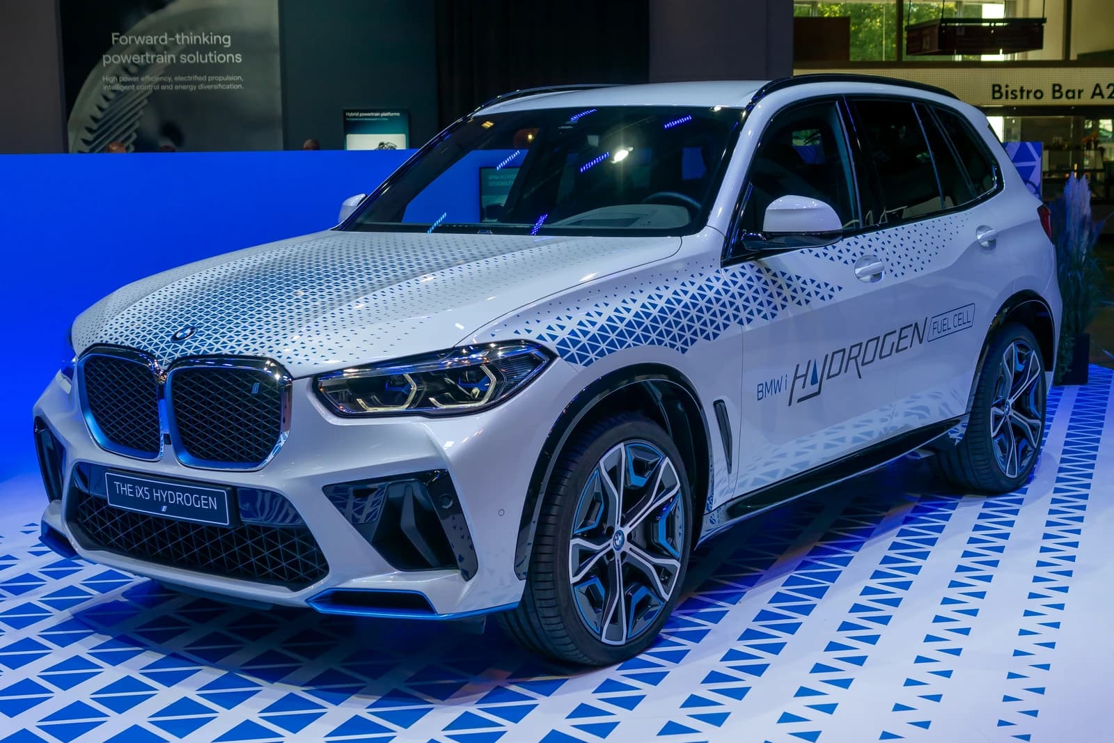 BMW iX5 Hydrogen fuel cell car parked at an auto show.