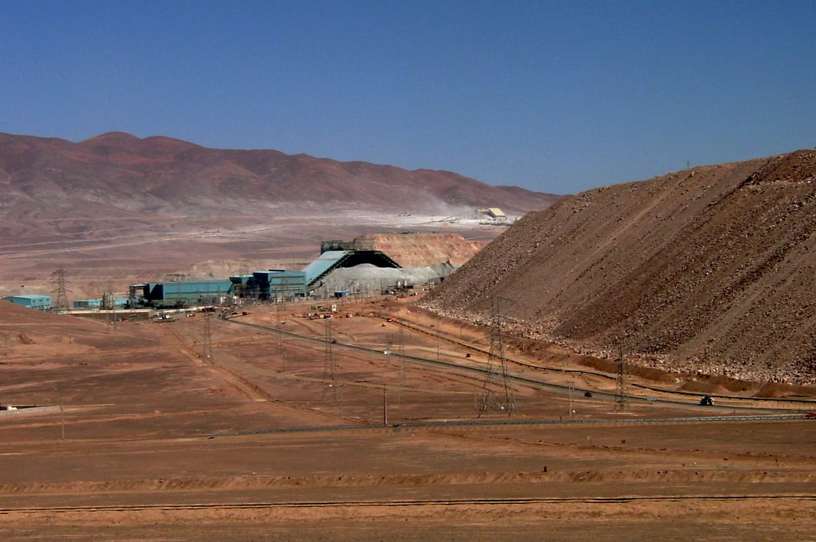 Panoramic view of buildings and conveyor belts at the La Escondida copper mine in Chile.