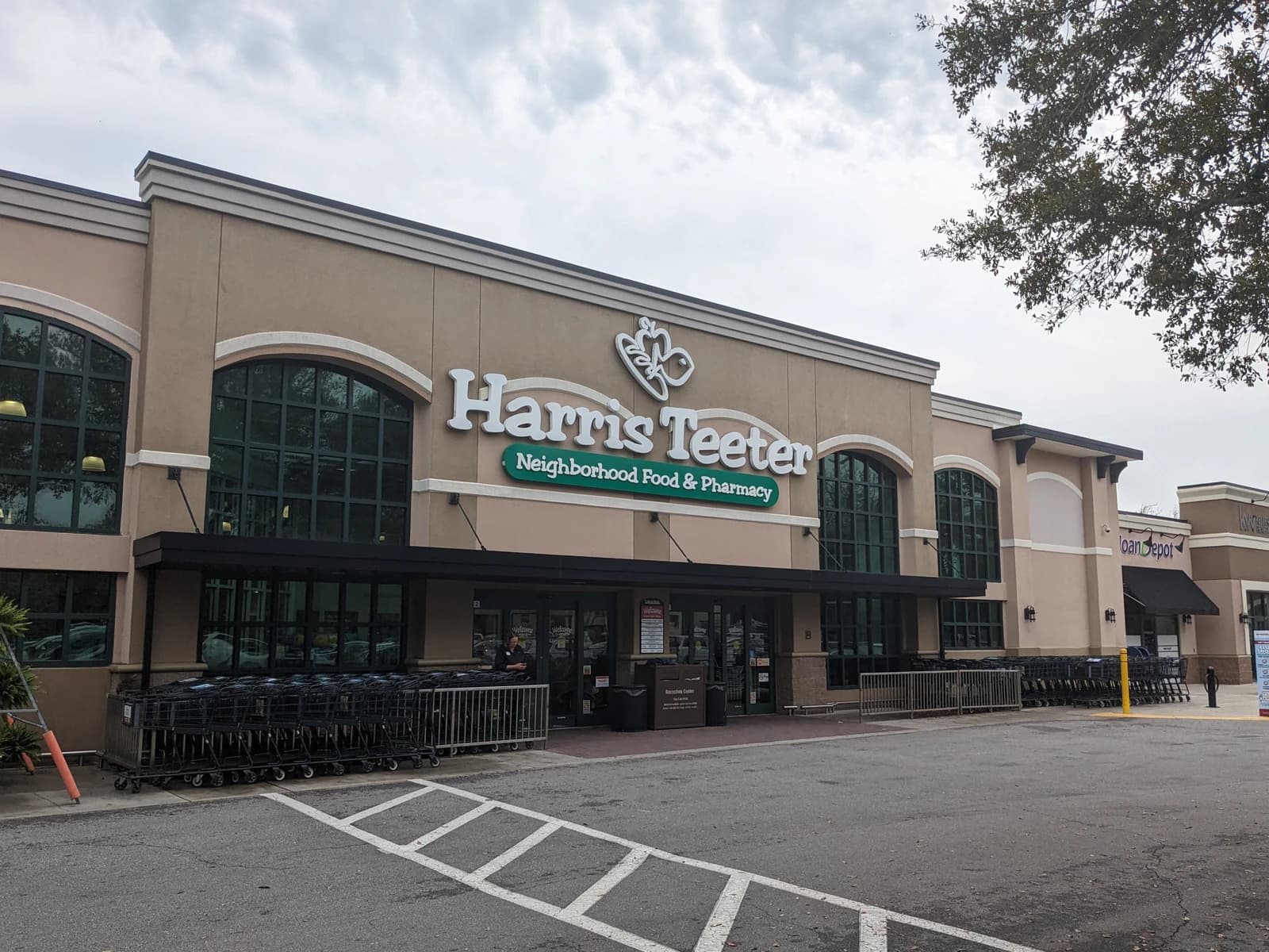 Exterior of a Harris Teeter grocery store building with shopping carts outside.