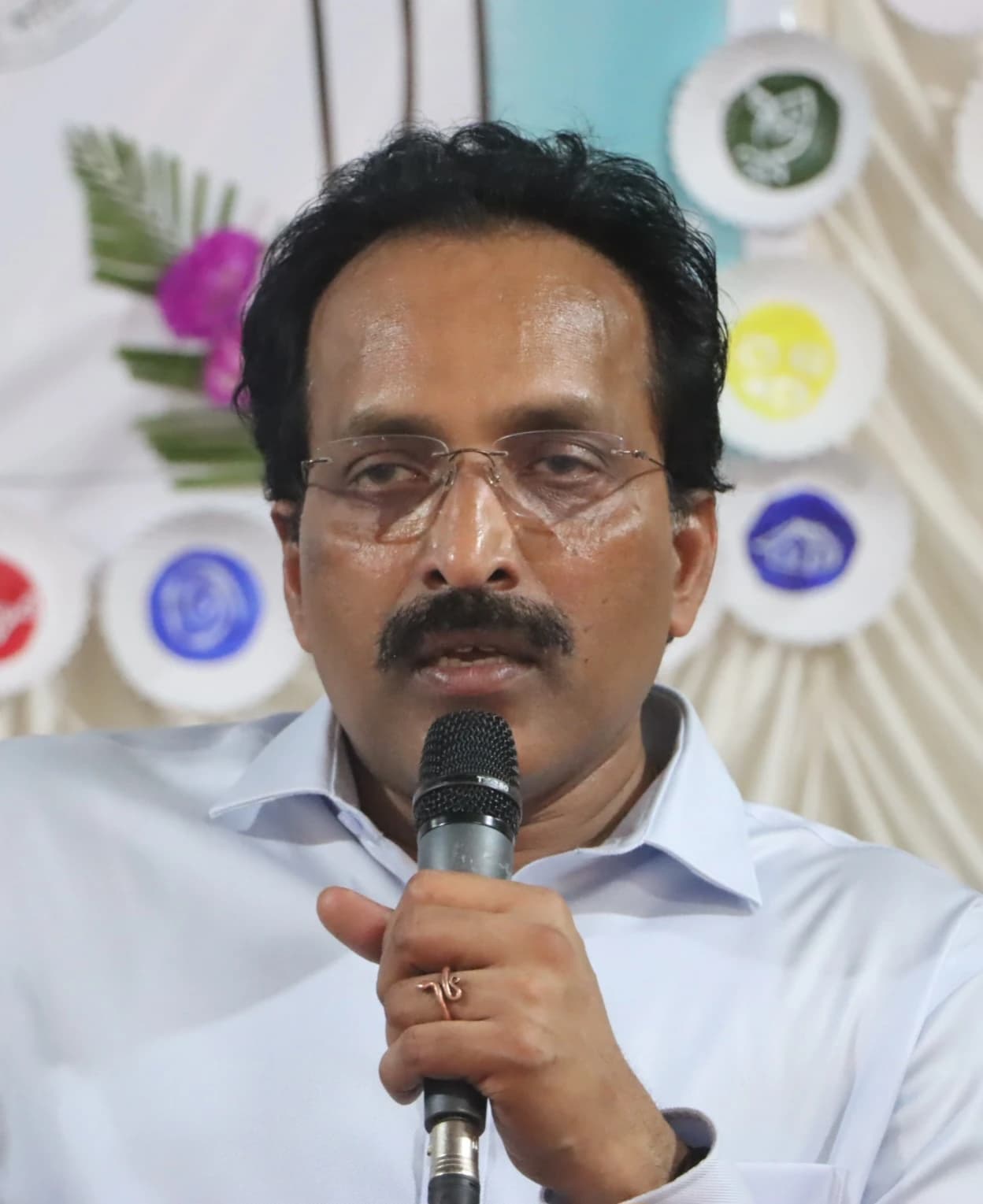 S. Somanath, Chairman of ISRO, speaking into a microphone at an event.