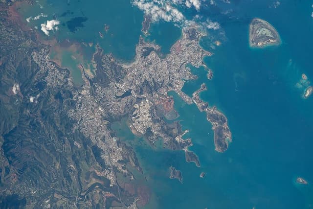 Satellite image of New Caledonia, showing landmass, urban development, and surrounding ocean.