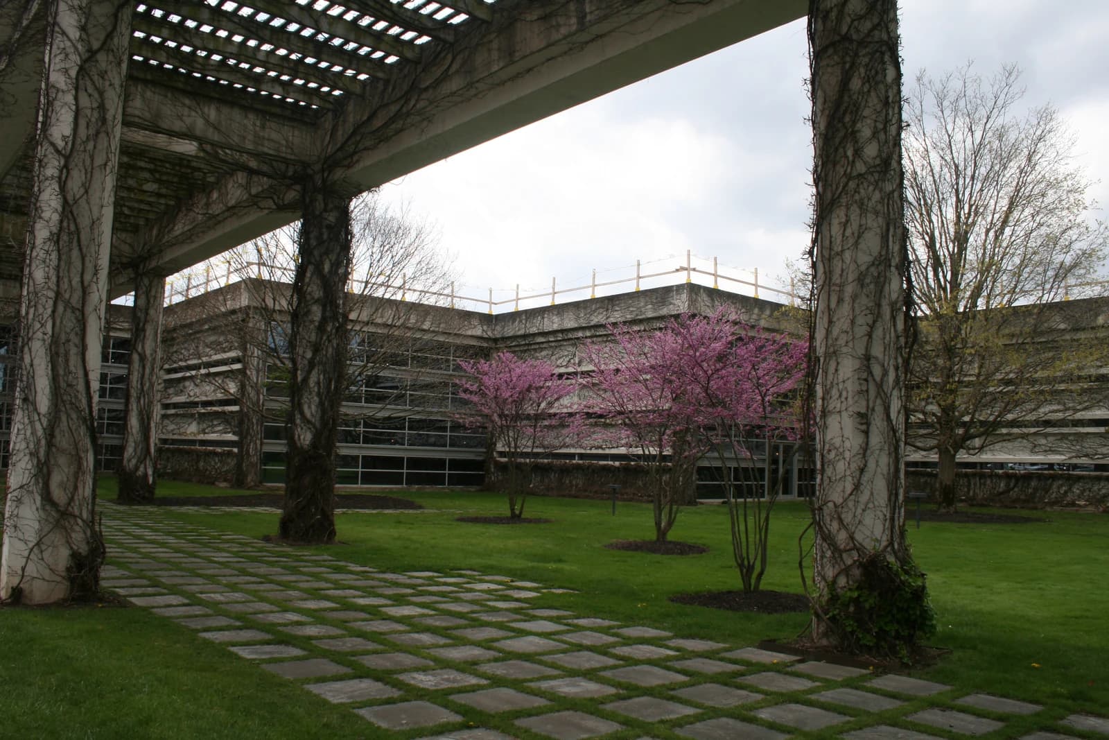 Exterior of Cummins Inc. Headquarters building in Columbus, Indiana, with trees and a pathway.