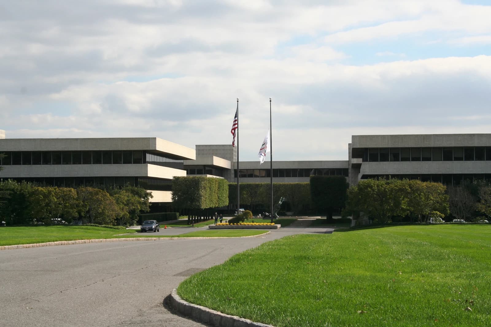 PepsiCo headquarters building in Purchase, New York under a partly cloudy sky.