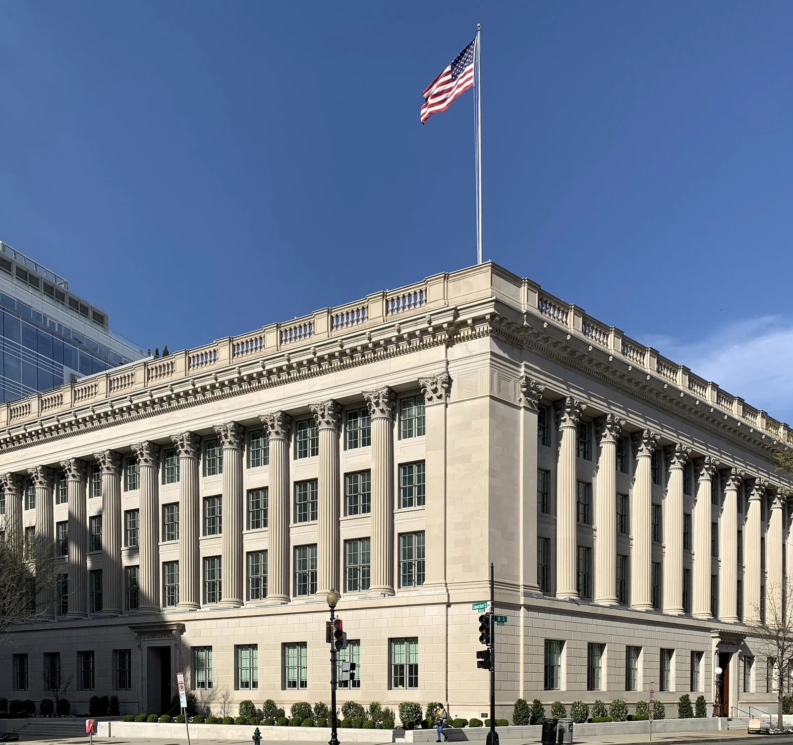 United States Chamber of Commerce Building exterior with American flag on a pole, clear blue sky.