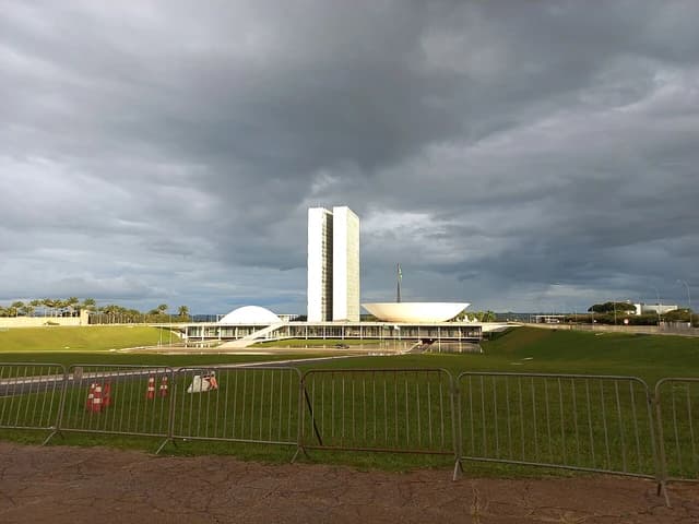 Brazilian National Congress building in Brasília, with two tall towers and domed structures.