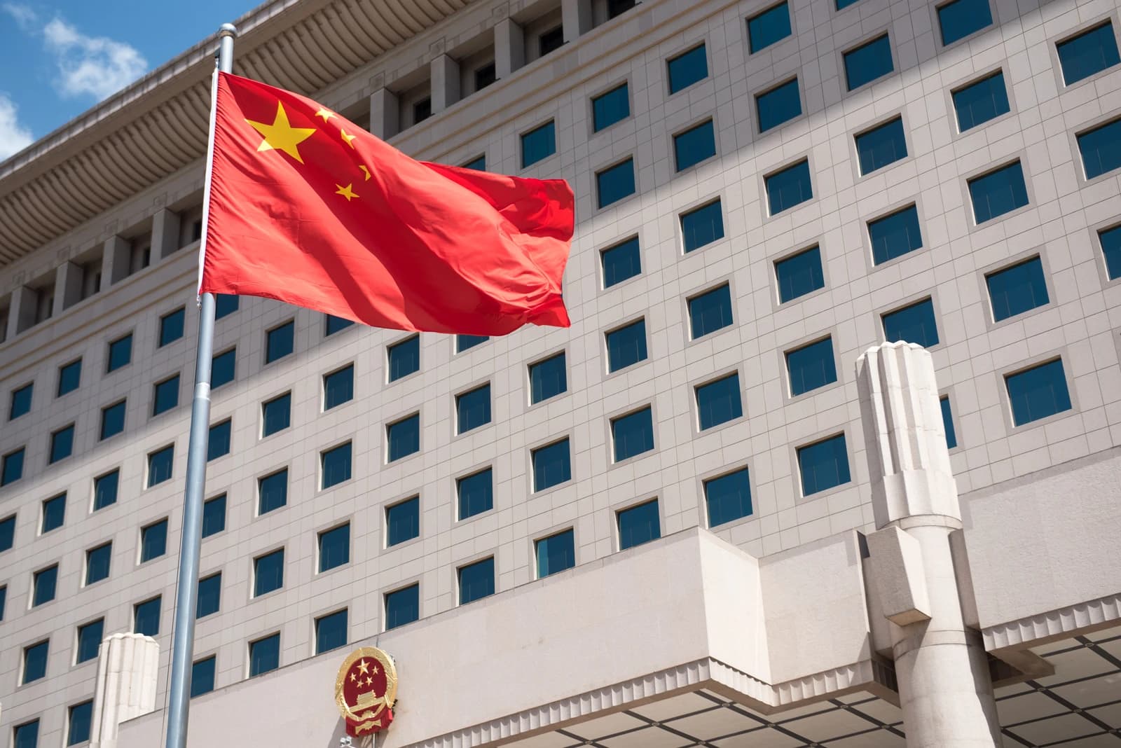 Chinese national flag flying above the Ministry of National Defense building in Beijing.