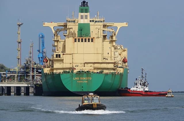 LNG Sokoto, a liquefied natural gas carrier, docked at a port with tugboats.