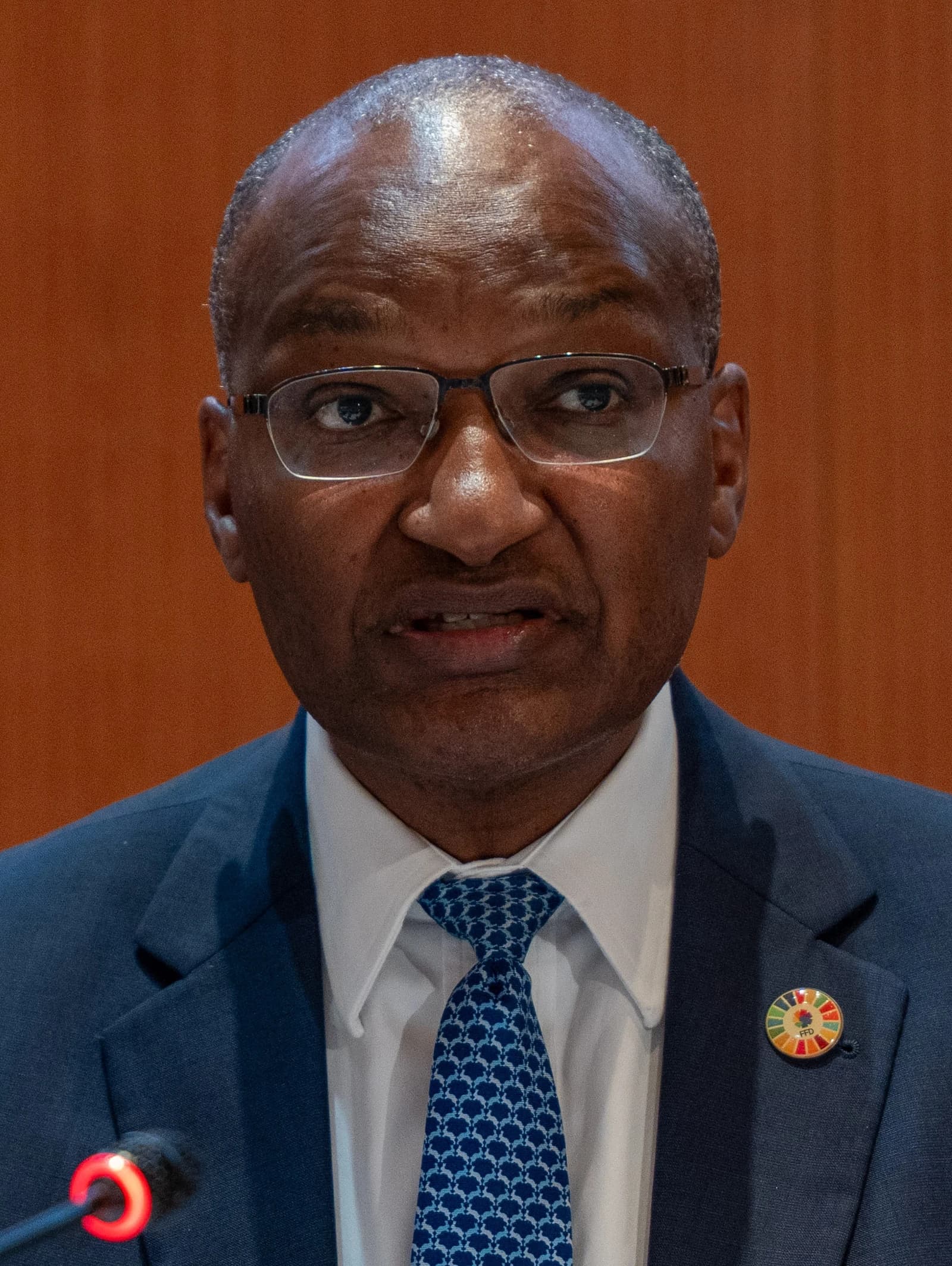 Patrick Njoroge, former Governor of the Central Bank of Kenya, speaking at a podium.