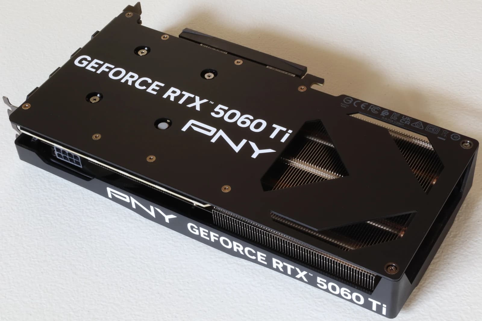 Rear view of an Nvidia GeForce RTX 5060 Ti graphics card on a white background.