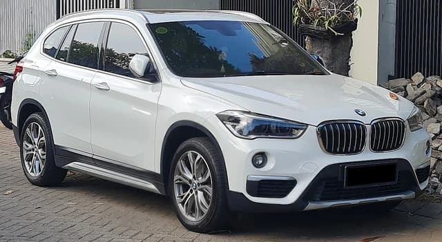 White 2020 BMW X1 sDrive18i parked outdoors in West Surabaya, Indonesia.