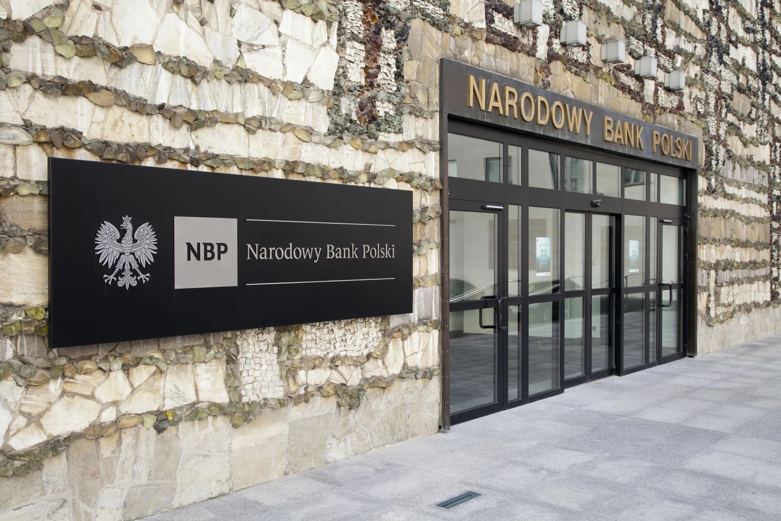 Signage for Narodowy Bank Polski, the National Bank of Poland, on a stone building facade.
