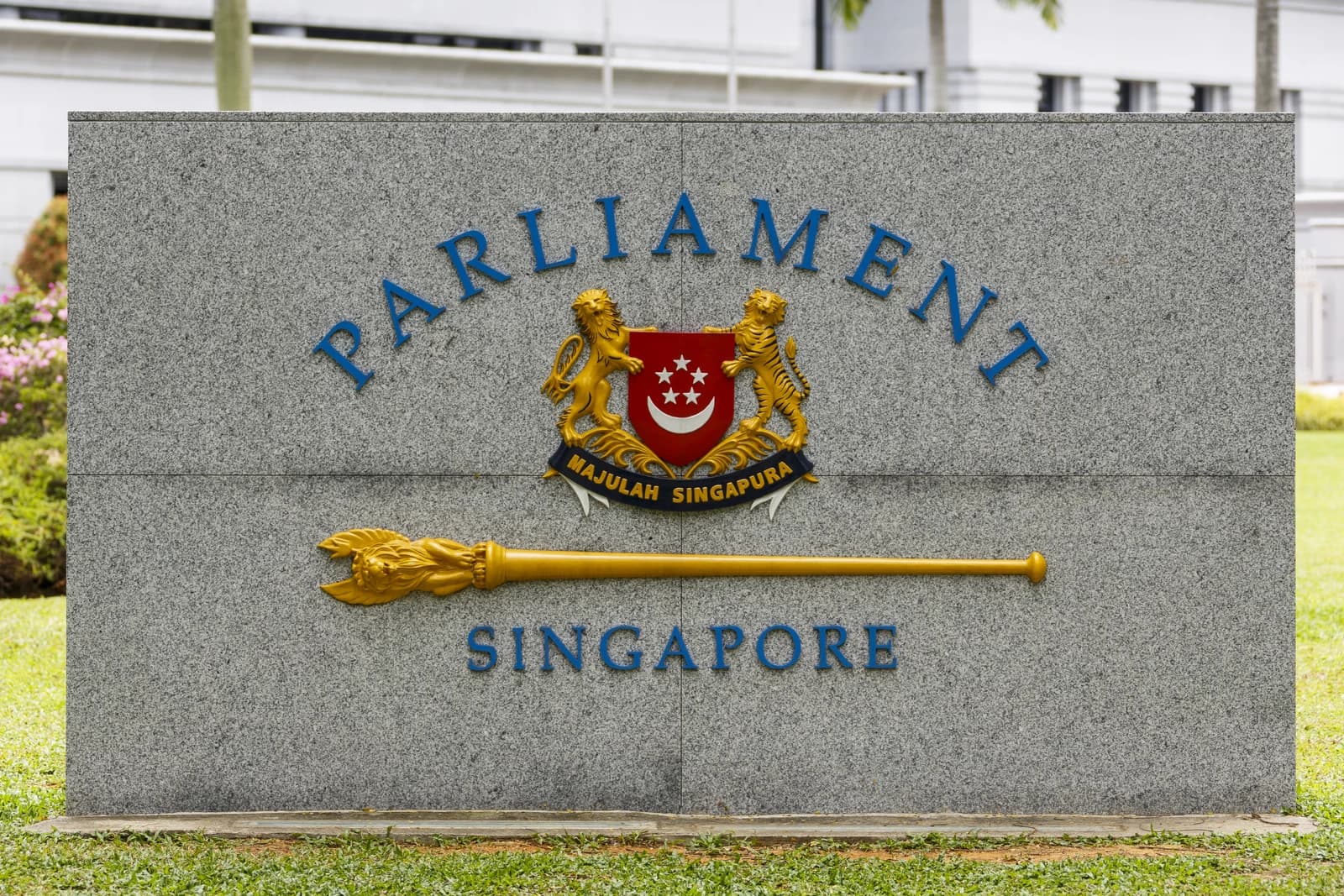 Sign for the Parliament of Singapore in front of a building.