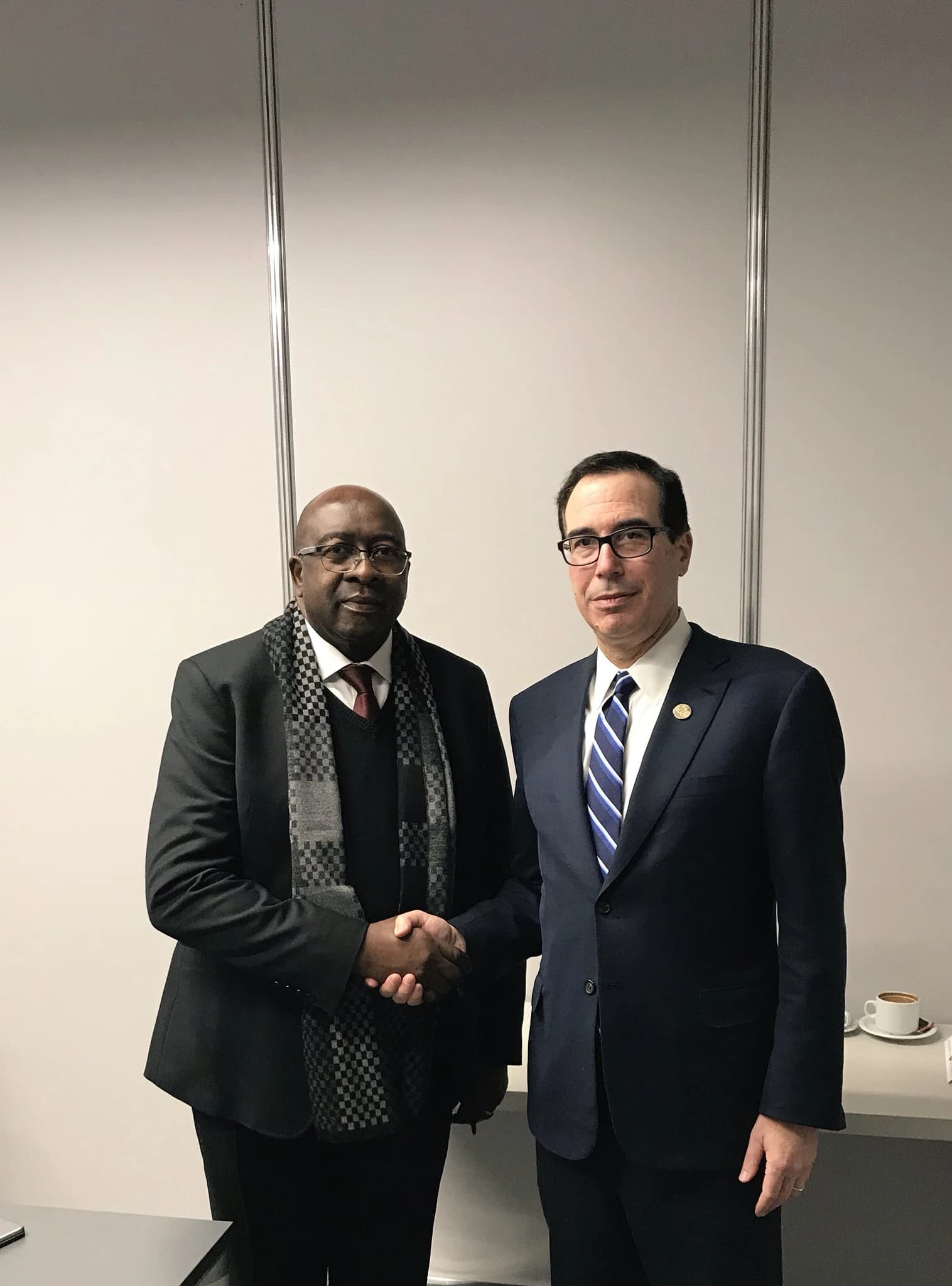 Steven Mnuchin, U.S. Treasury Secretary, and Nhlanhla Nene, South African Minister of Finance, shaking hands.