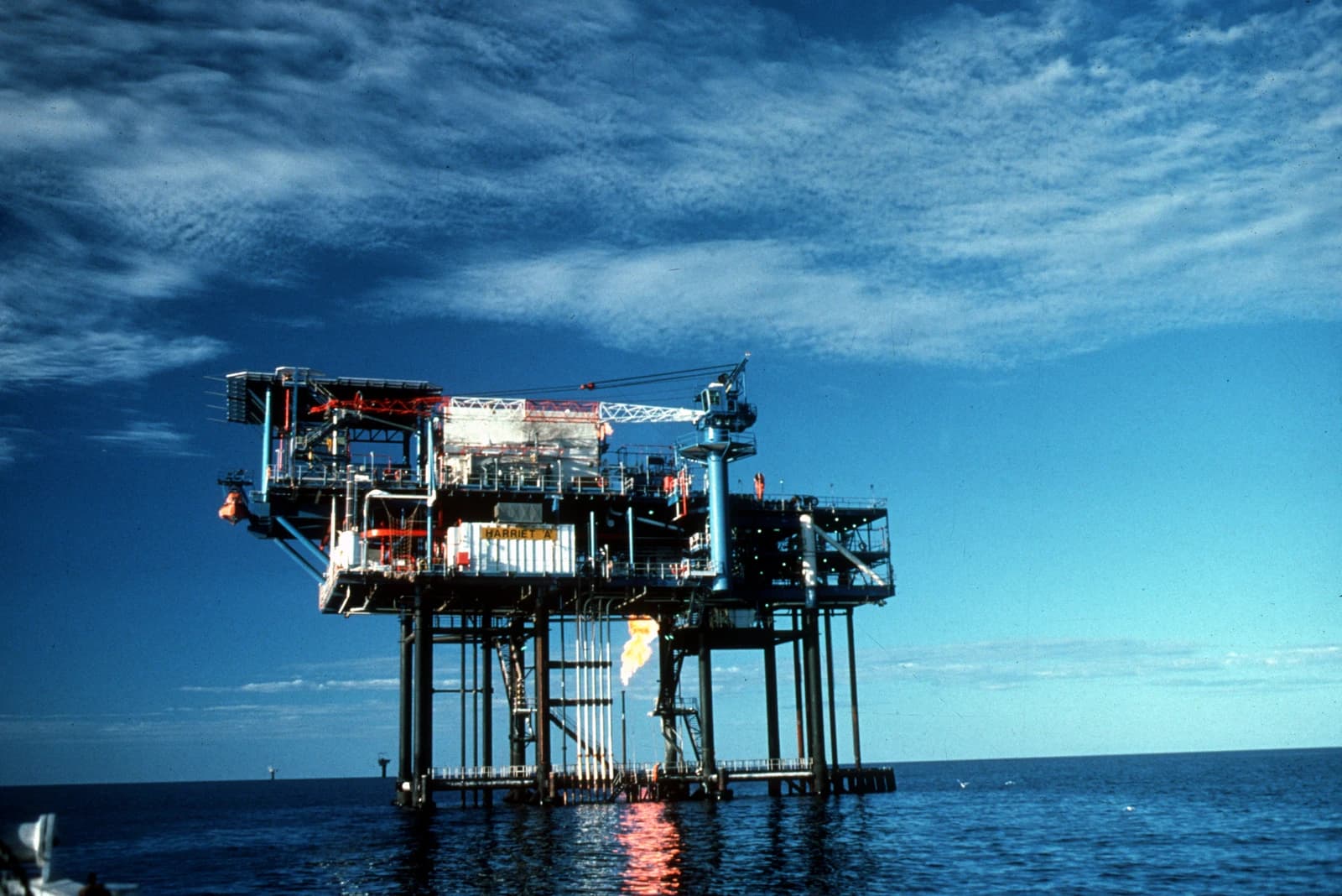 An oil and gas drilling platform operating offshore in the ocean.