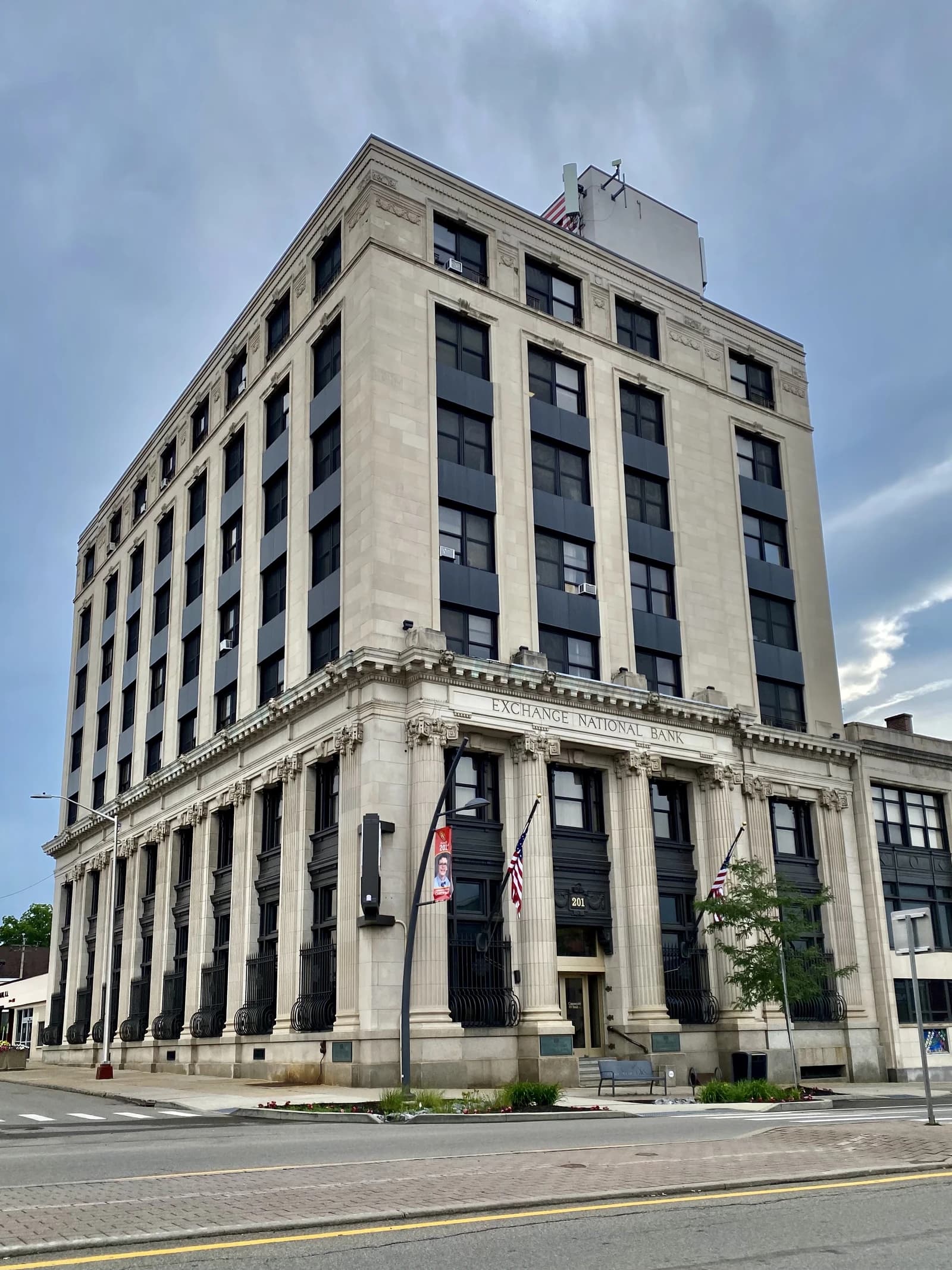 Exchange National Bank building, a multi-story stone structure with columns.