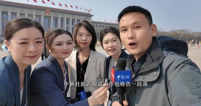 Group of journalists from China News Service holding microphones and reporting outdoors.