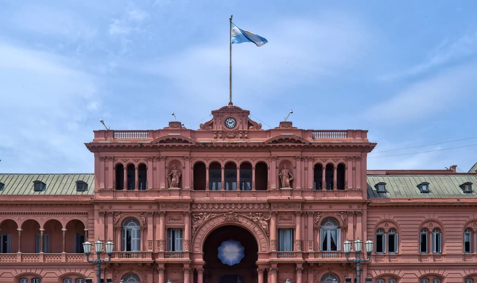 Casa Rosada, the official residence of the President of Argentina, under a blue sky.