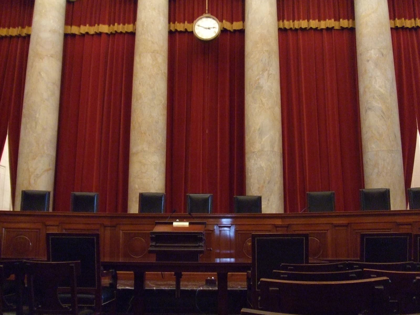 Interior of the United States Supreme Court building, showing the courtroom bench and seating.