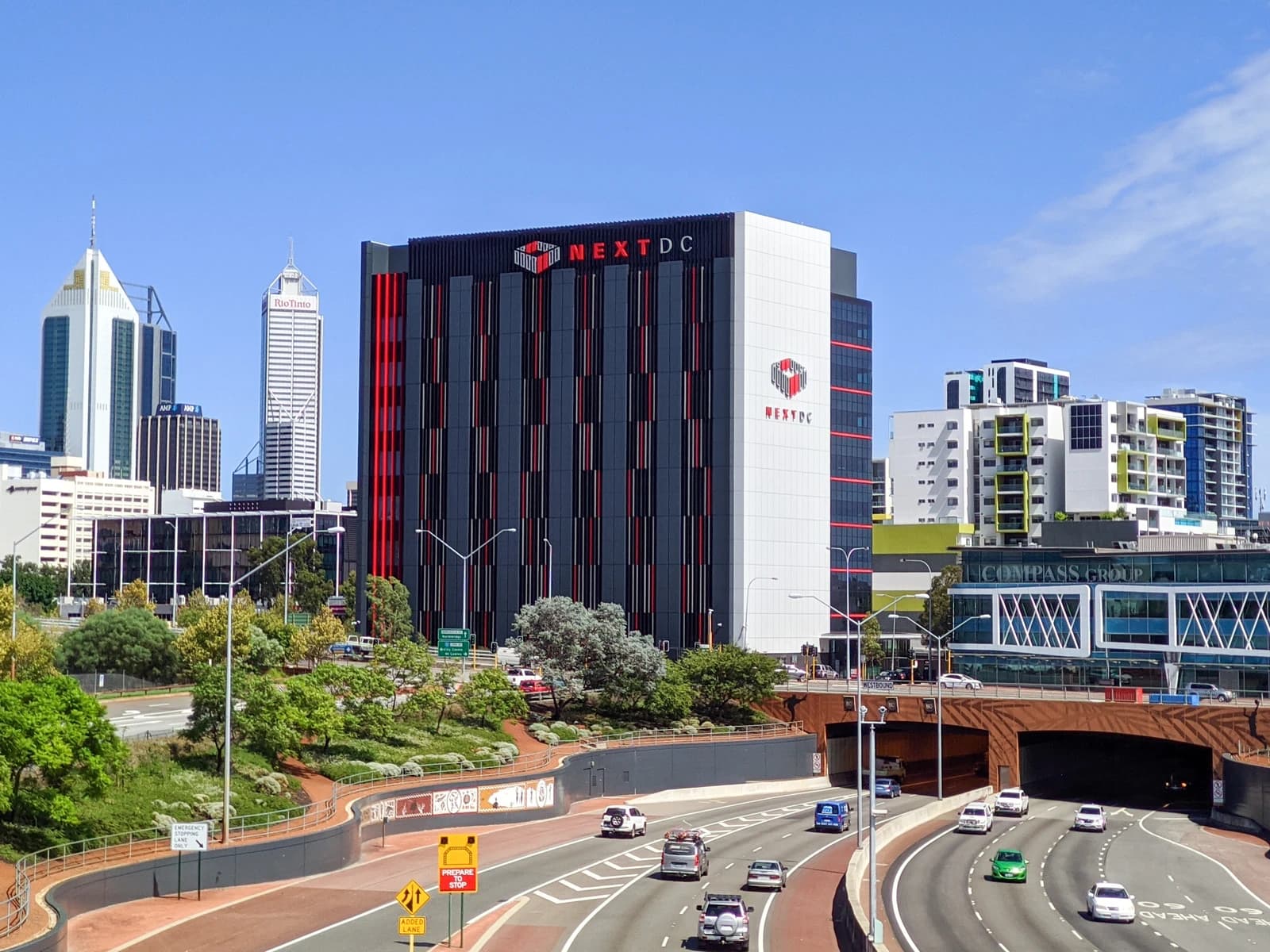NEXTDC data centre building in Perth, Australia, with multiple lanes of traffic.