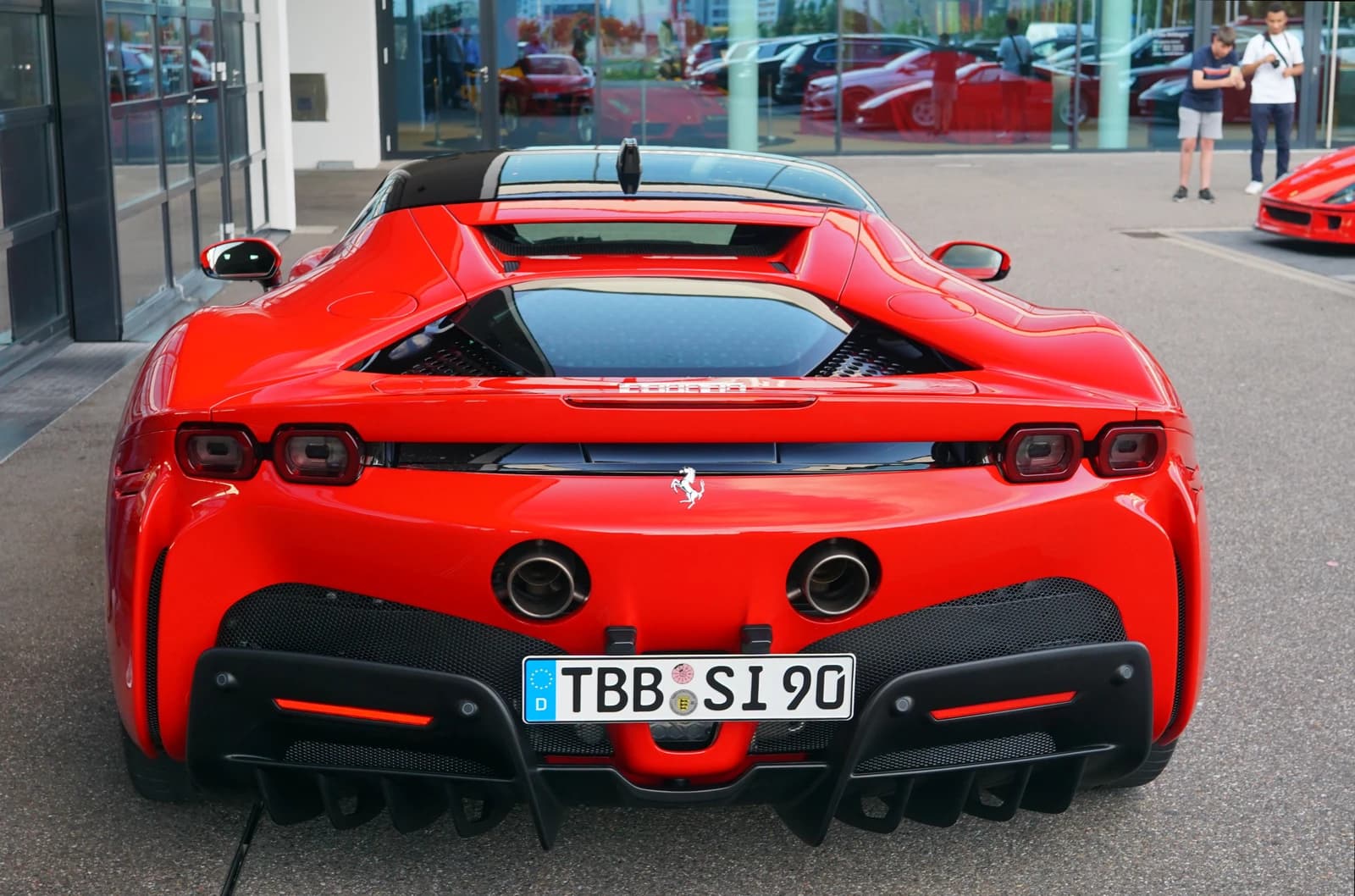Red Ferrari SF90 Stradale, rear view, parked outdoors in Böblingen.