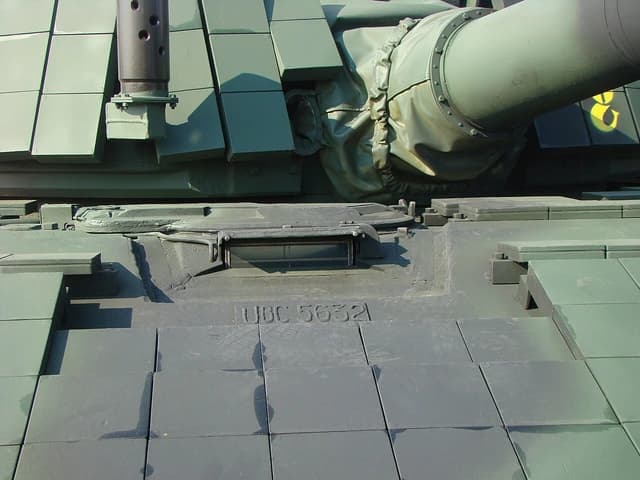Close-up of a PT-91 Twardy tank showing its gun turret and hull detail.