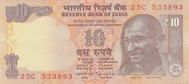 Close-up of a 10 Rupee Indian banknote with Mahatma Gandhi's portrait.